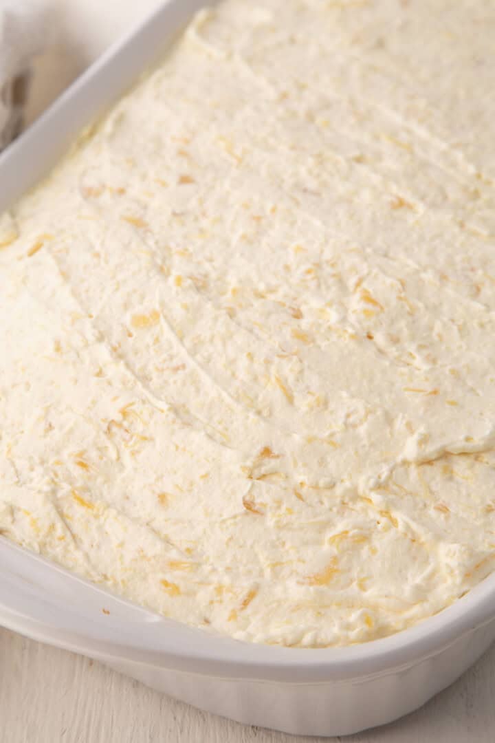whole mandarin orange cake frosted with a fluffy cool whip pineapple frosting.