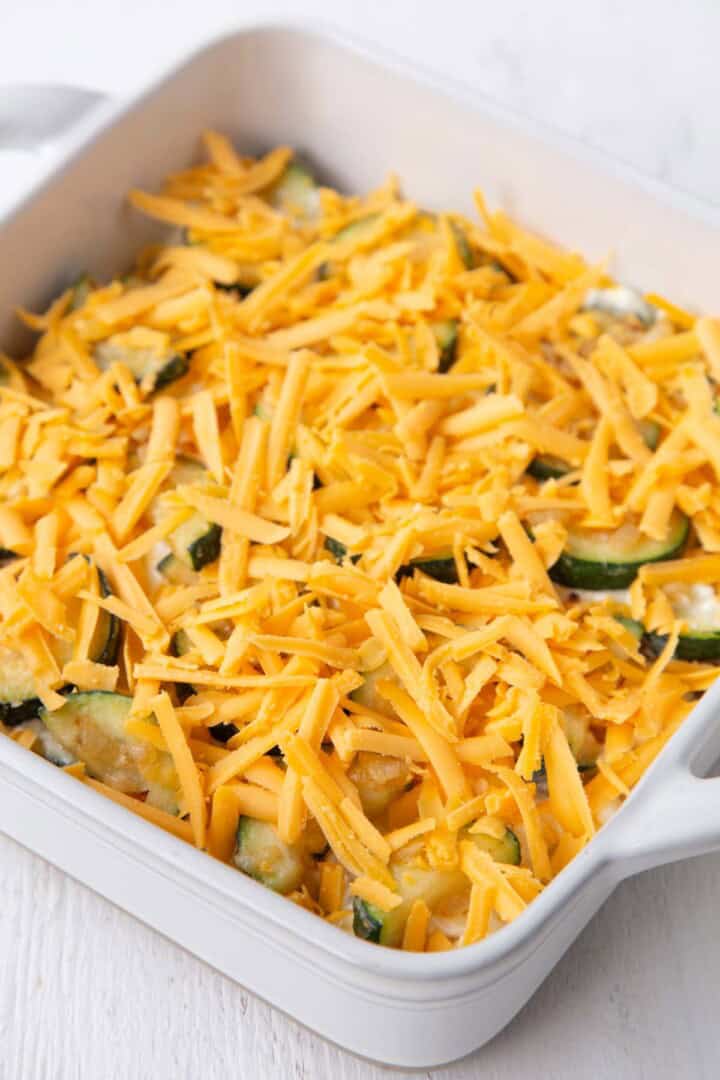 shredded cheddar on top of a zucchini sausage casserole.