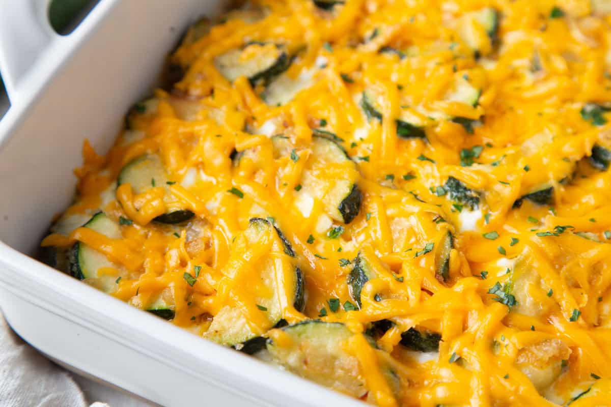 zucchini sausage casserole covered with melted shredded cheese.