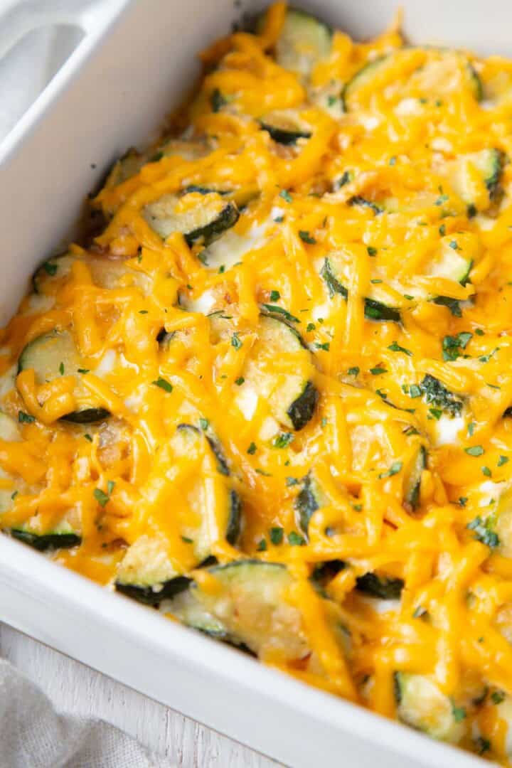 melted cheddar on top of a zucchini and italian sausage casserole.