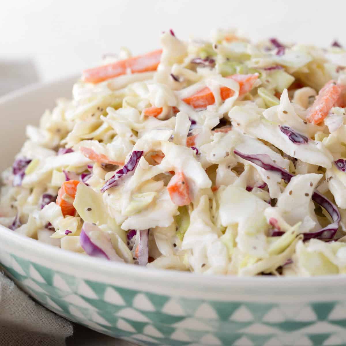 simple bowl of coleslaw with carrots and red cabbage in a mayo dressing.