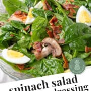 spinach salad with hard boiled eggs and bacon.