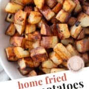 crispy cubes of home fried potatoes in a white bowl.