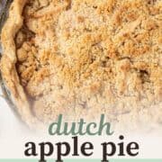 a whole apple pie topped with a brown sugar crumble in a flaky pastry crust.