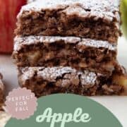 apple oat bars stacked on top of each other, topped with powdered sugar.