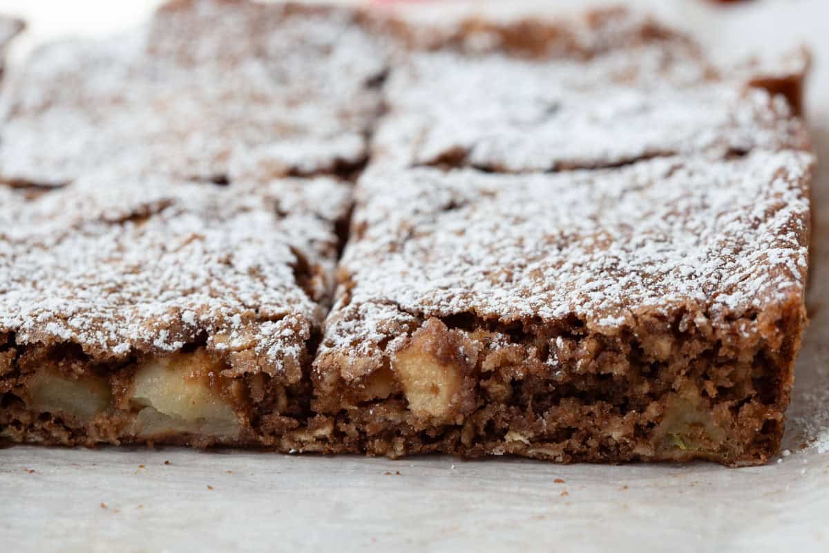 sliced apple oat bars topped with powdered sugar.