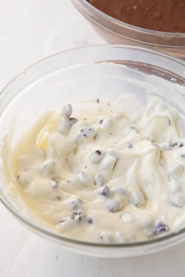 cream cheese and sugar mixture with chocolate chips in a glass bowl.