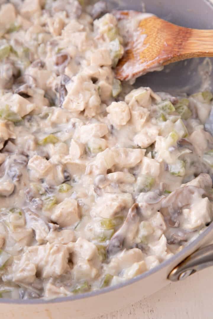 chicken stroganoff in a creamy cream of mushroom soup sauce in a skillet.