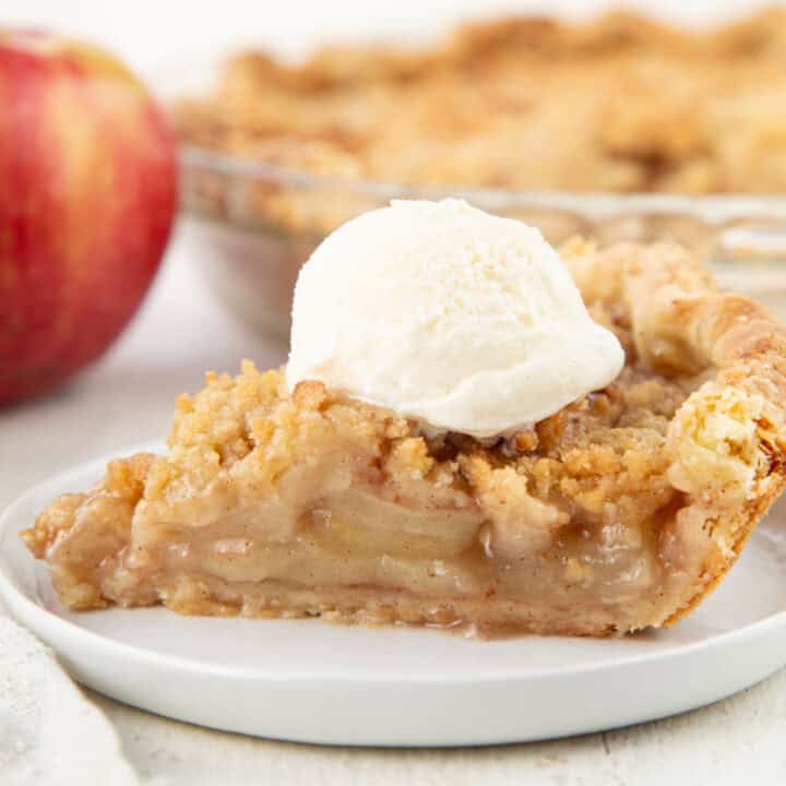 slice of dutch apple pie with a scoop of ice cream on top.