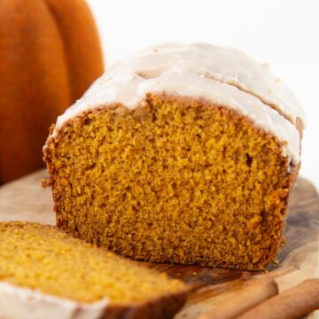 slices of pumpkin bread with a white powdered sugar glaze on top.
