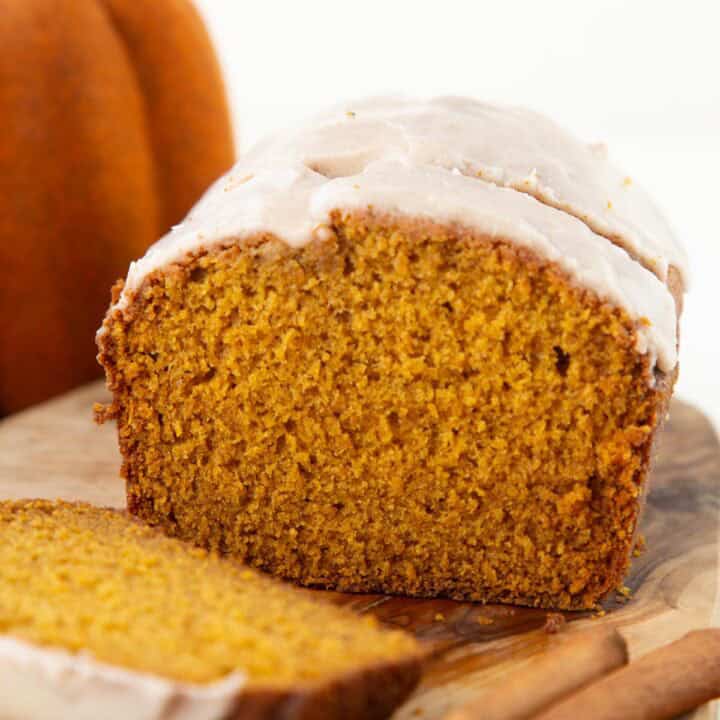 slices of pumpkin bread with a white powdered sugar glaze on top.