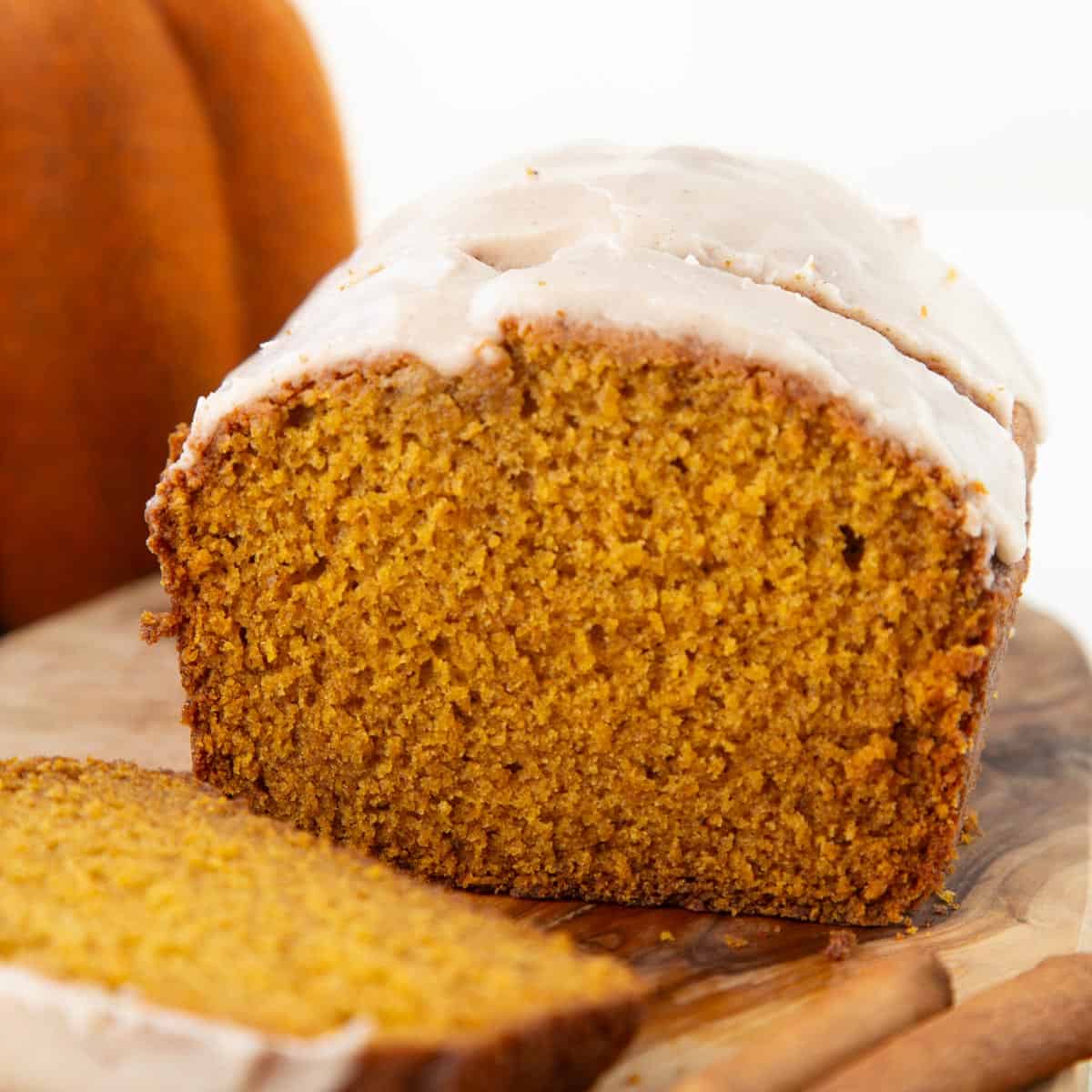 slices of pumpkin bread with a white powdered sugar glaze on top.