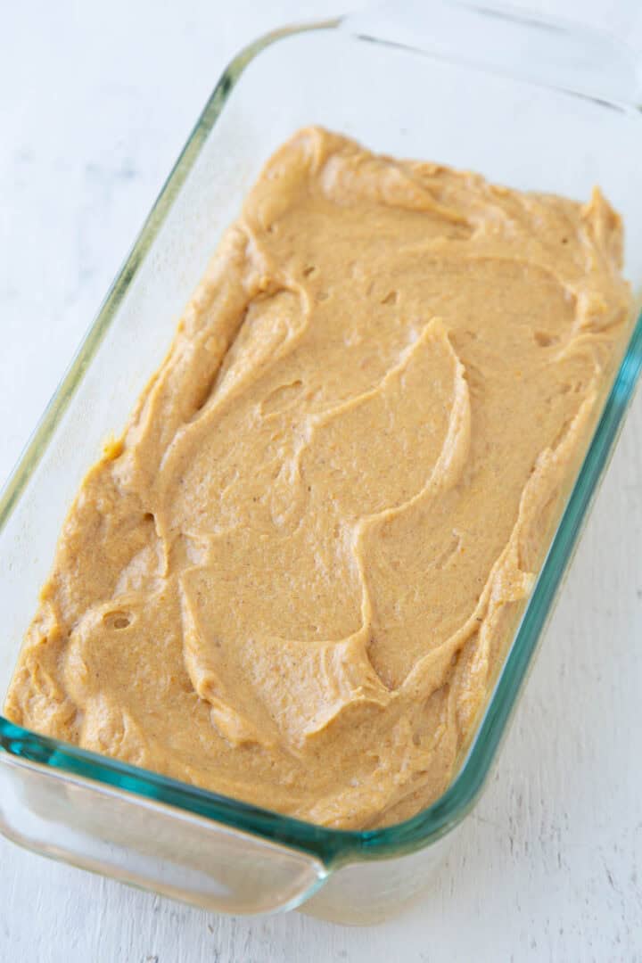 pumpkin bread batter in a glass bread pan.