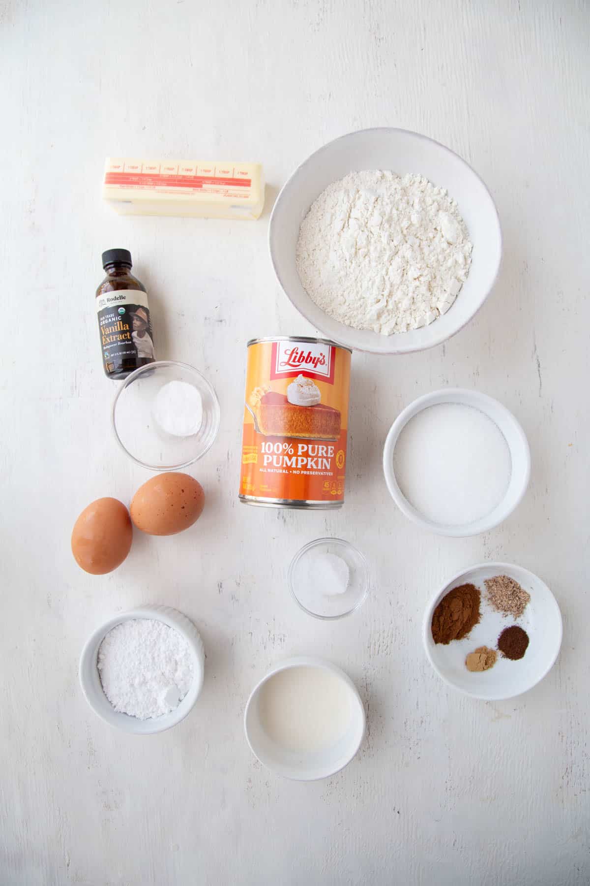 a can of pumpkin, eggs, flour, sugar, and other pumpkin bread ingredients.